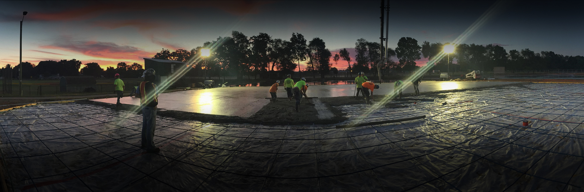 Concrete being poured for tennis courts